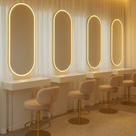 Salon interior with oval mirrors and stools under warm lighting